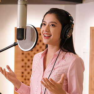 Picture of a female voice talent in the voice over booth.